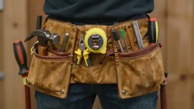 Person with Tool Belt Working in Workshop garage