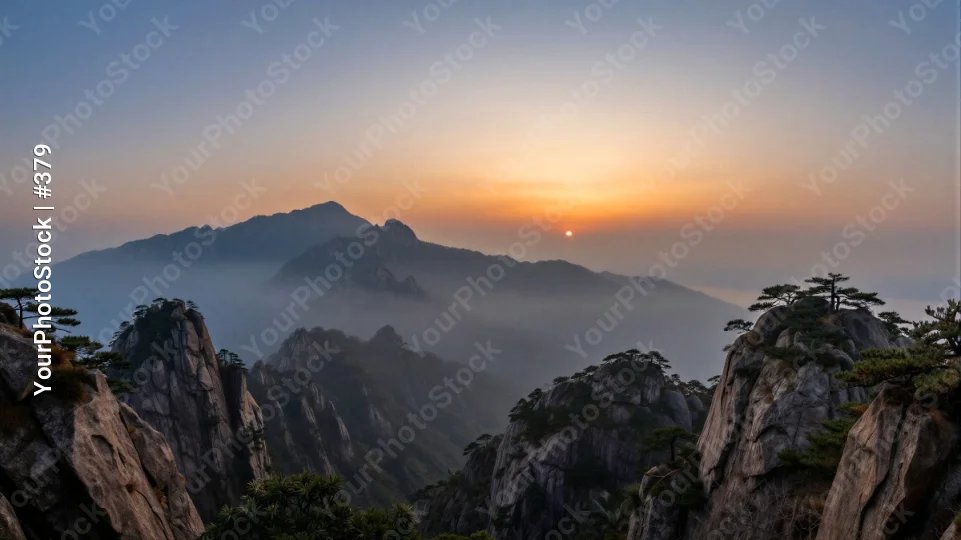 Mountain Range at Sunrise with Foggy Peaks landscape