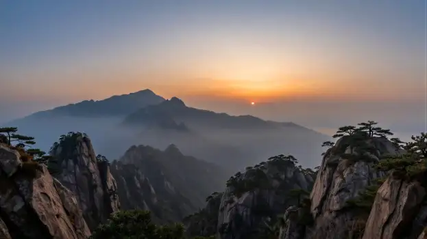 Mountain Range at Sunrise with Foggy Peaks landscape