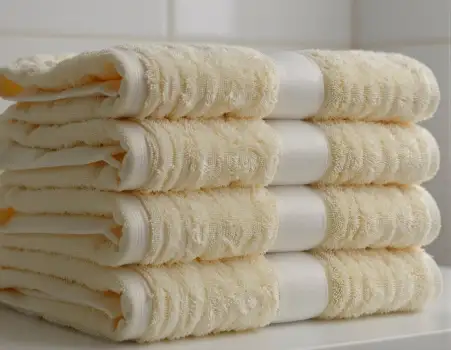 Neatly Folded White Towels with Lace Pattern soft hotel