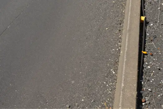 Freshly Paved Road with Caution Tape asphalt paving