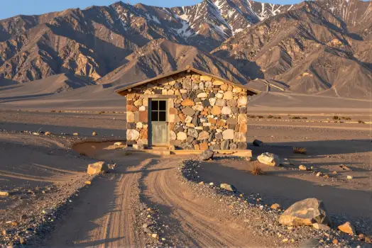 Desert Cabin in Snow-Capped Mountains stone building
