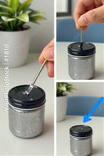 Person Using Spoon to Scoop Liquid from Metal Jar