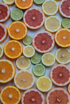 Sliced Oranges and Limes on White Background fruit arrangement