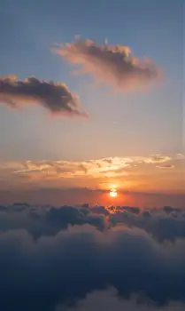 Serene Sunset Over Ocean blue sky calm water white clouds