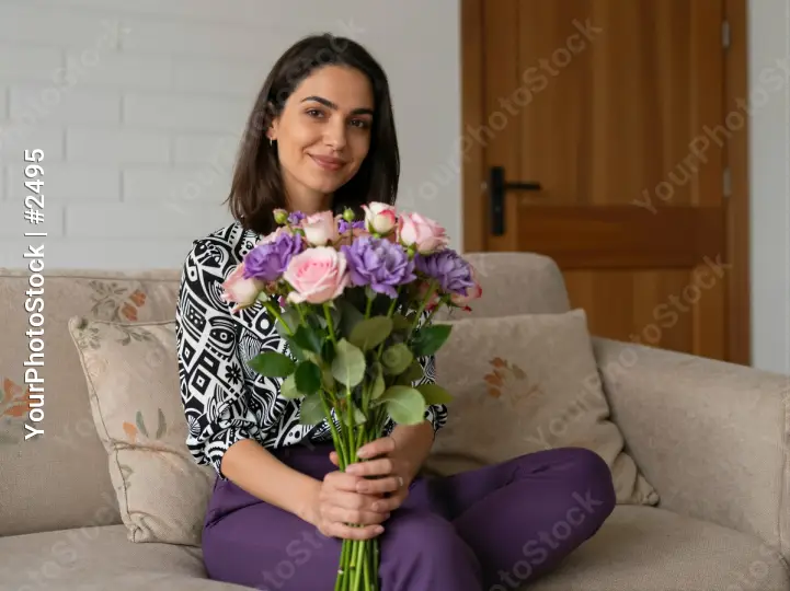 Young woman holding flowers on couch bouquet roses mom mother woman