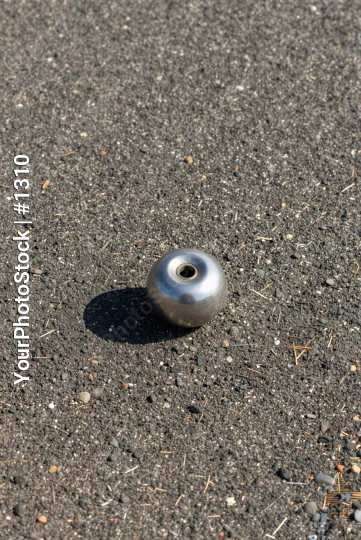 Metallic Object on Asphalt hole pebbles twigs