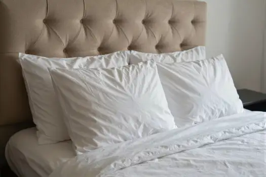 Close-up of a minimalist bed with white sheets and pillows hotel