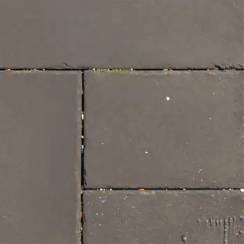 Gray tiled floor with grid pattern and cleaning marks