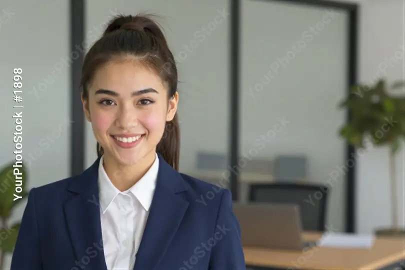 Confident Young Woman in Office Smiling professional