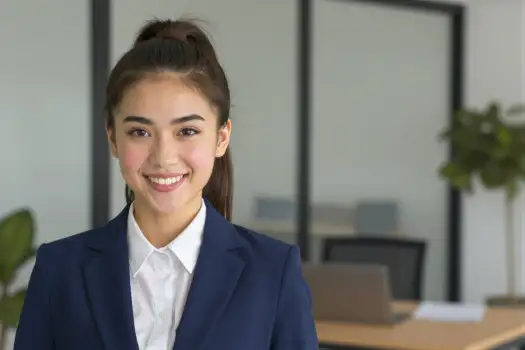 Confident Young Woman in Office Smiling professional