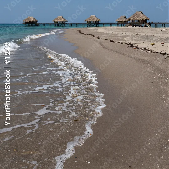 Serene Beach Scene with Wooden Piers and Thatched Huts
