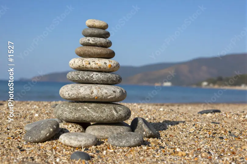 Stack of Pebbles on Sandy Beach pyramid stones