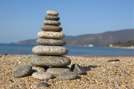 Stack of Pebbles on Sandy Beach pyramid stones