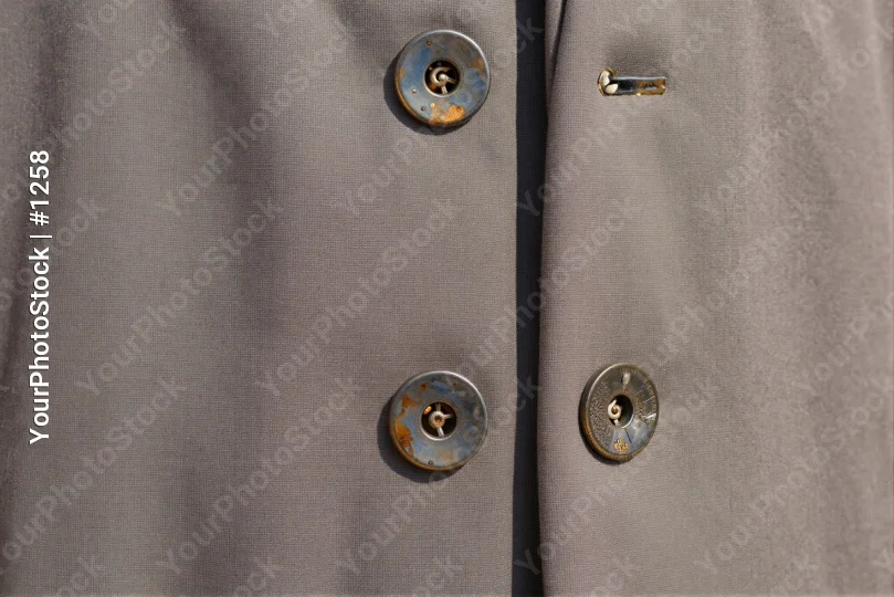 Close-up of Beige Trousers with Silver Metal Buttons and Gold Hook