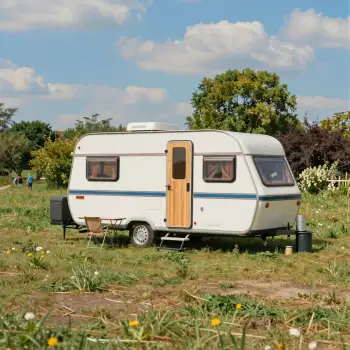 White Caravan in Grass Field dandelions wooden