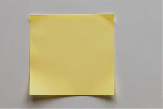 Crumpled Yellow Paper on White Background texture sticky note