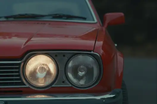 Vintage Red Car Grille and Headlights sleek design