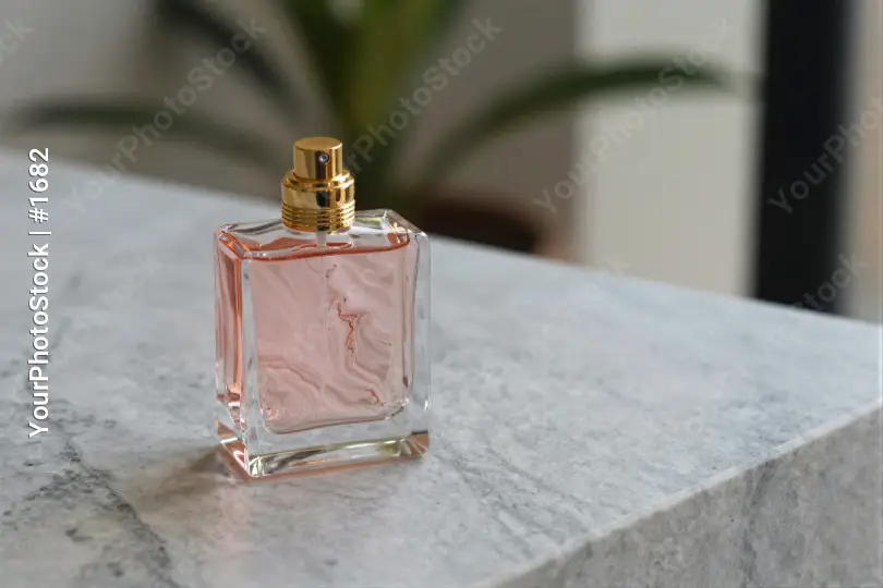 Minimalist Pink Perfume Bottle on Marble Surface