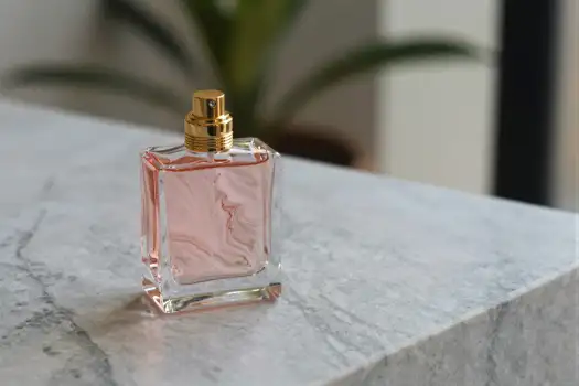 Minimalist Pink Perfume Bottle on Marble Surface