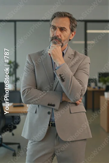 Middle-aged man in office deep in thought thoughtful business man