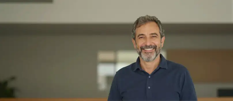 Middle-aged man with beard smiling mustache room business corporate