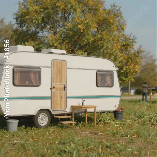 Autumnal White Caravan in Grass Field trees wooden door