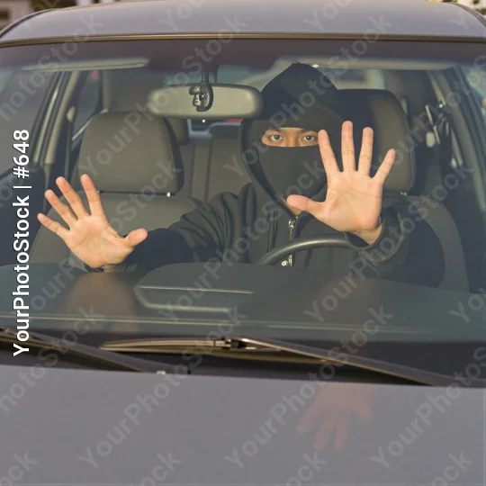 Person Making Stop Gesture in Driver Seat car thief