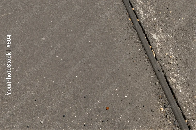 Wet Asphalt Road with Markers pebbles parallel