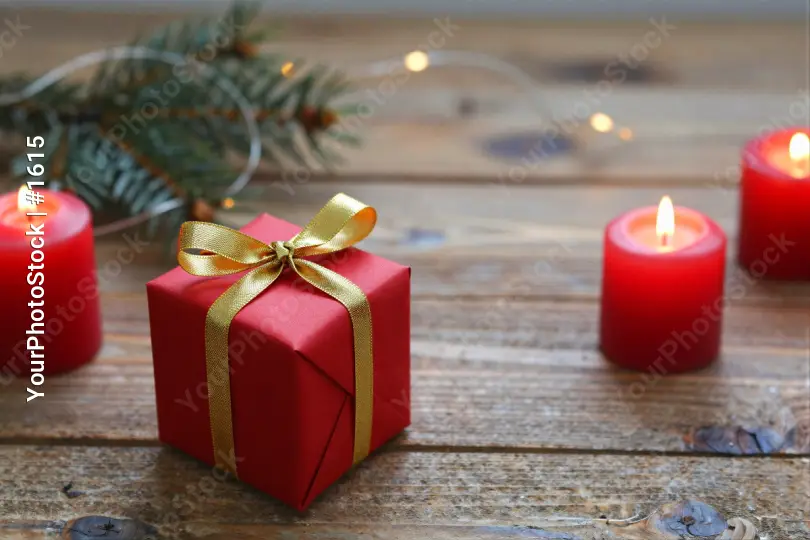 Red Gift Box with Gold Ribbon on Wood wooden surface
