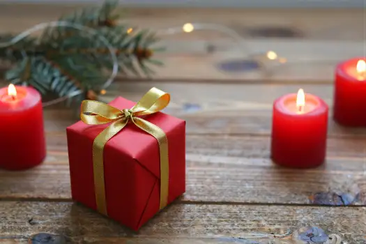 Red Gift Box with Gold Ribbon on Wood wooden surface