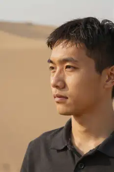 Young Asian Man in Desert Landscape sand dunes