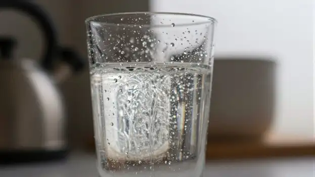Glass of Water with Bubbles on Kitchen Countertop