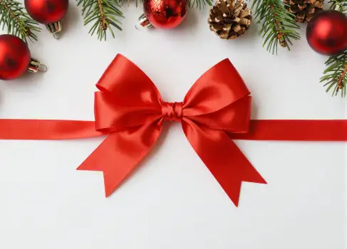 Red Ribbon with Bow and Christmas Ornaments flat lay gift