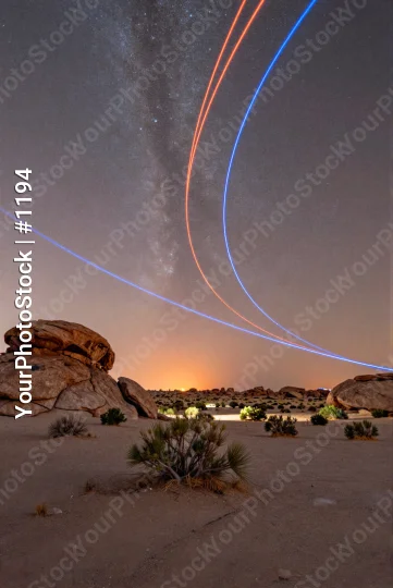 Night Desert Landscape with Starry Sky and Light Trails