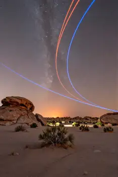 Night Desert Landscape with Starry Sky and Light Trails