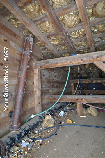 unfinished construction interior with wooden beams and insulation