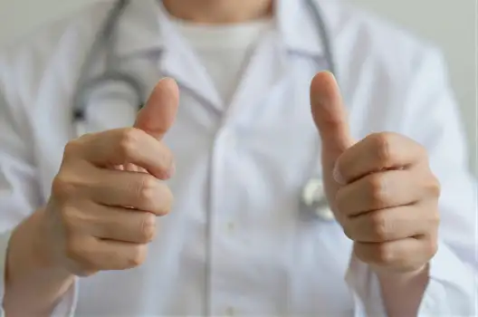 Doctor's Hands Thumbs Up Lab Coat Stethoscope Medical Setting