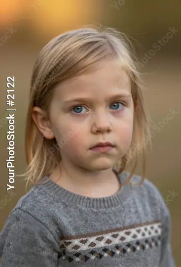 Serious Young Girl with Blonde Hair Looking Directly at Camera kid