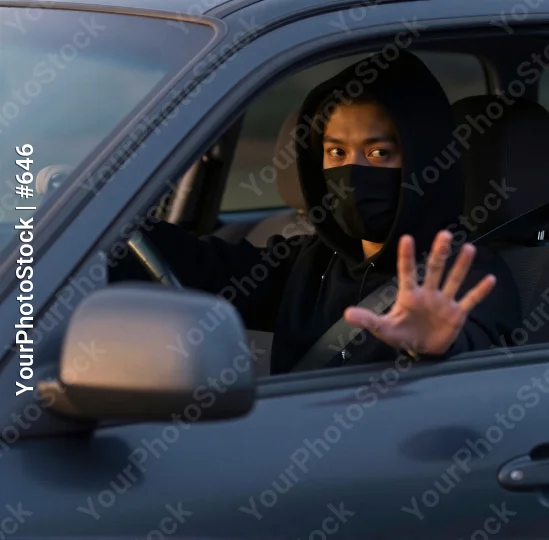 Man in Black Hoodie and Mask Making Stop Sign in Car thief