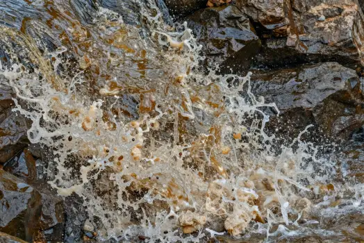 Serene Stream Over Rocks water frothy bubbles