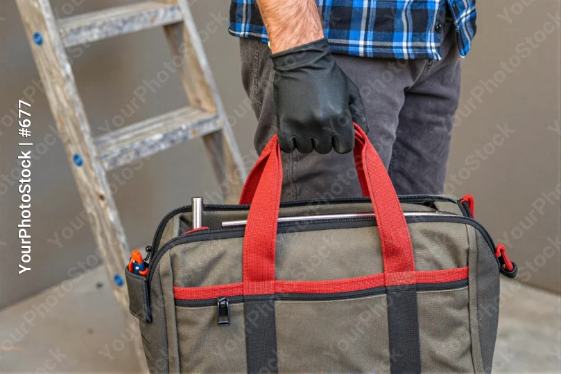 Person Holding Duffel Bag plaid shirt gloves grey bag worker