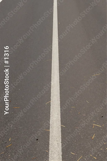 Smooth white line on uneven gray asphalt uneven surface