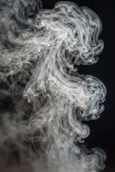 Mysterious White Smoke Swirling on Black Background