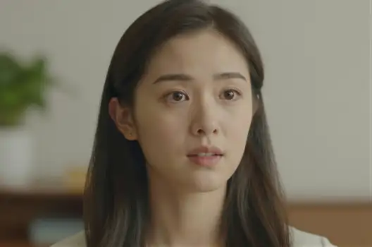 Serious Woman in White Blouse Looking Directly at Camera asian