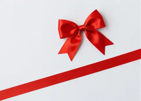 Red Ribbon with Large Bow on White Background gift