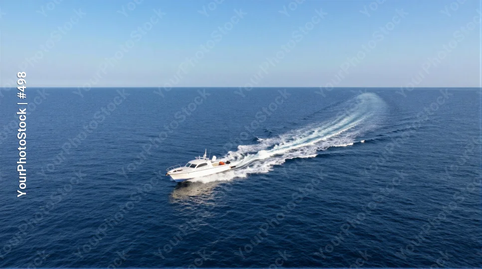 White Motorboat Sailing Across Ocean trail water