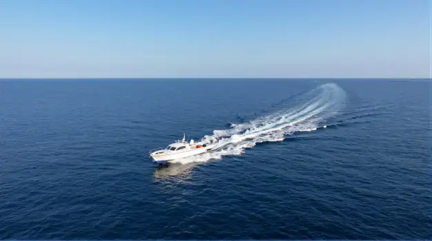 White Motorboat Sailing Across Ocean trail water