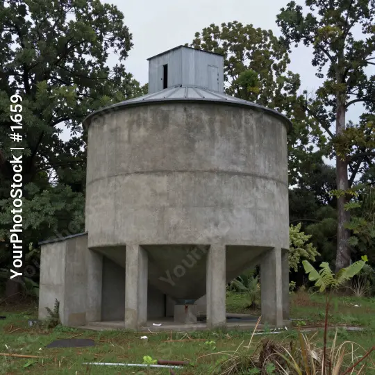 Old Concrete Water Tank with Dome in Overcast Sky