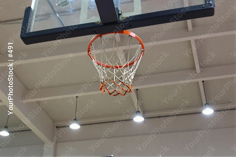 Basketball Hoop Hanging From Ceiling In Gymnasium